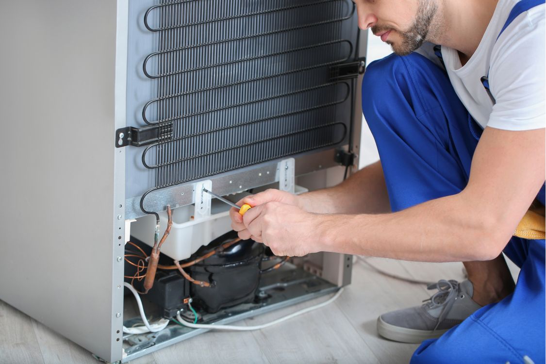 Technician repairing a refrigerator compressor in San Leandro