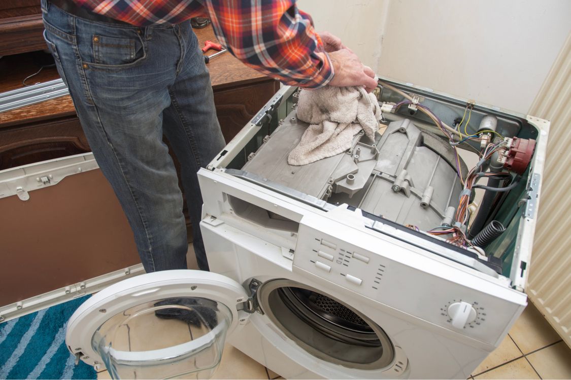 Technician repairing a washing machine drum in San Leandro